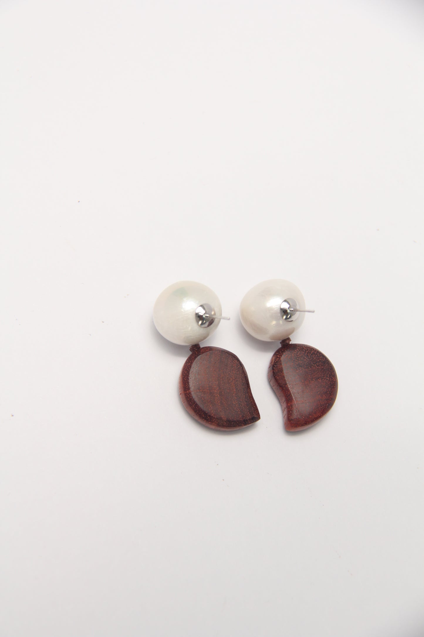 Earrings: pearls, zambia rosewood
