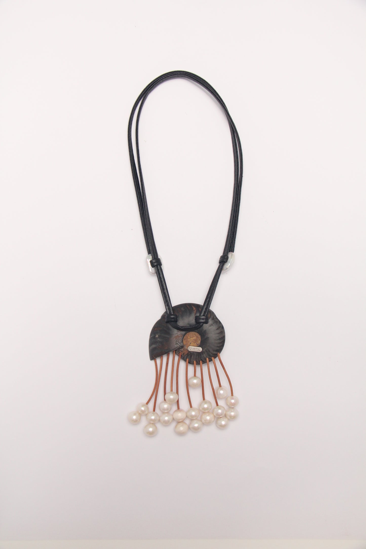 Pendant: ammonite fossil, leather, pearls