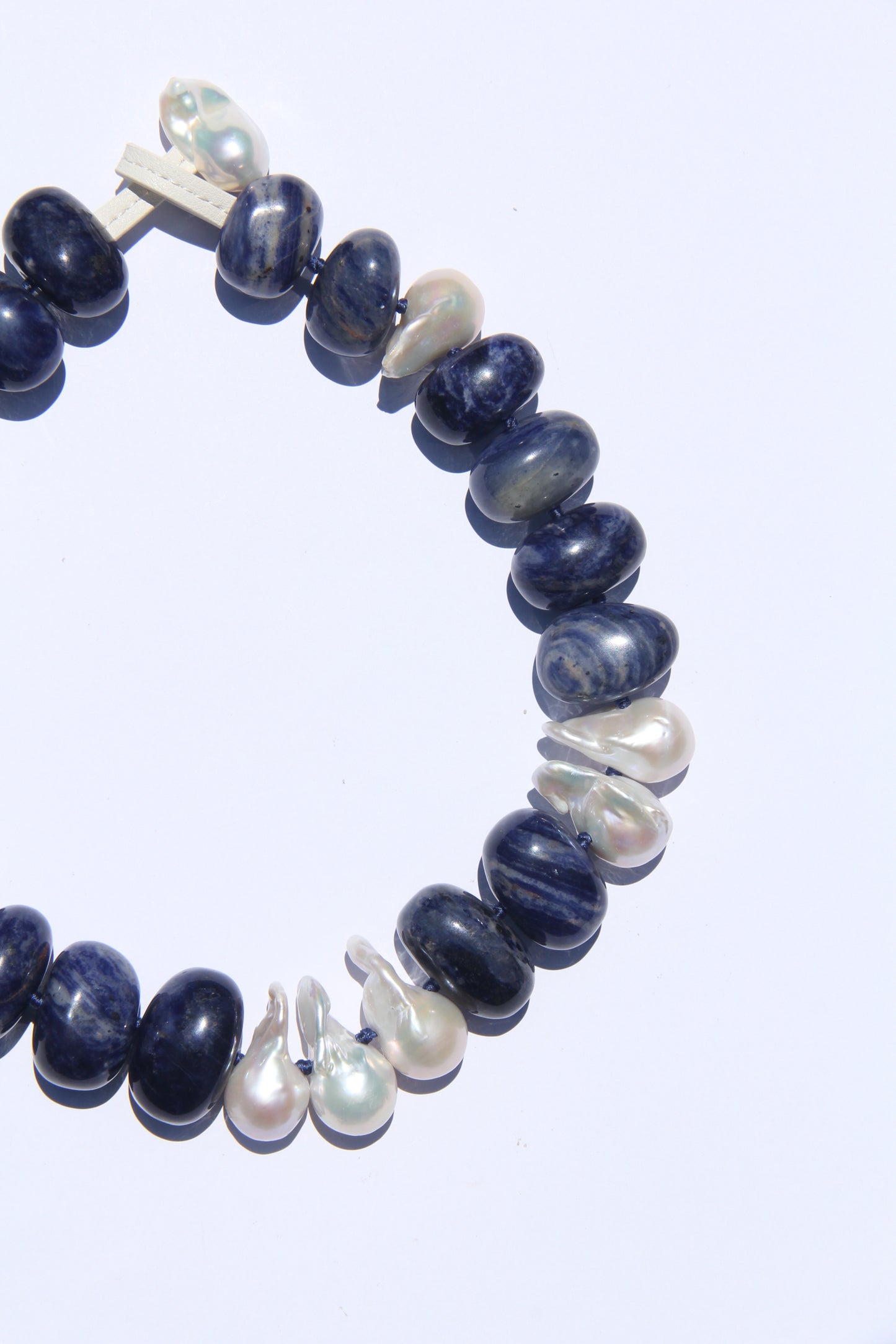 Necklace: pearls, blue vein stone