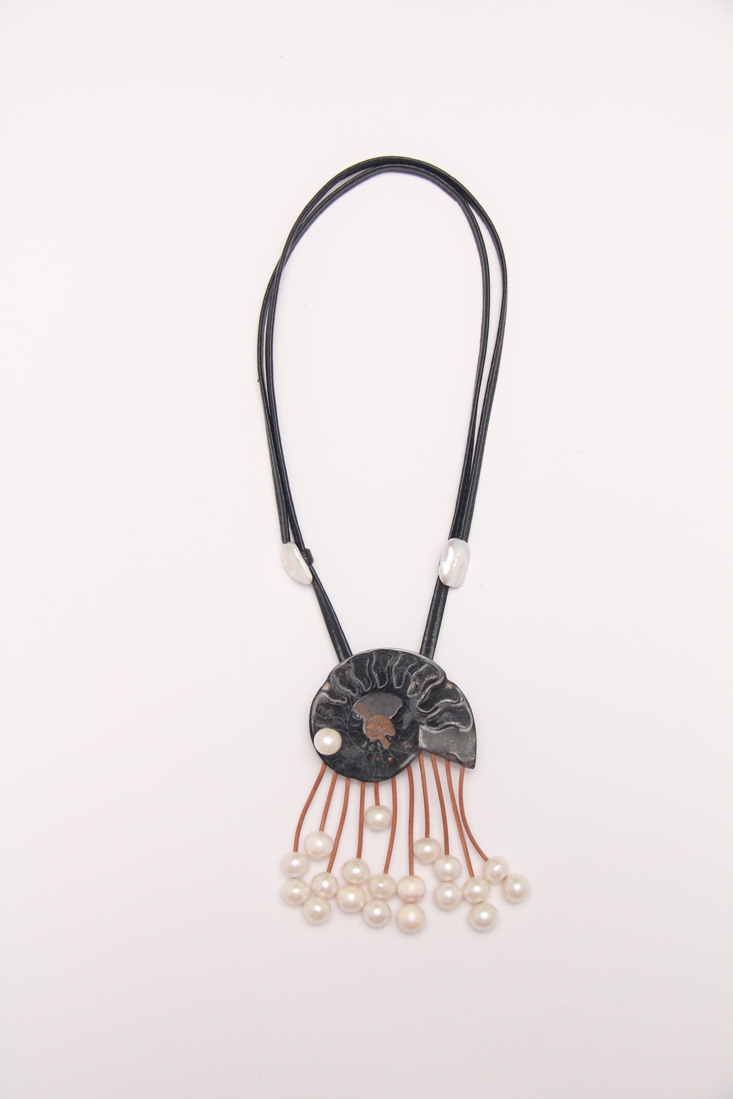 Pendant: ammonite fossil, leather, pearls