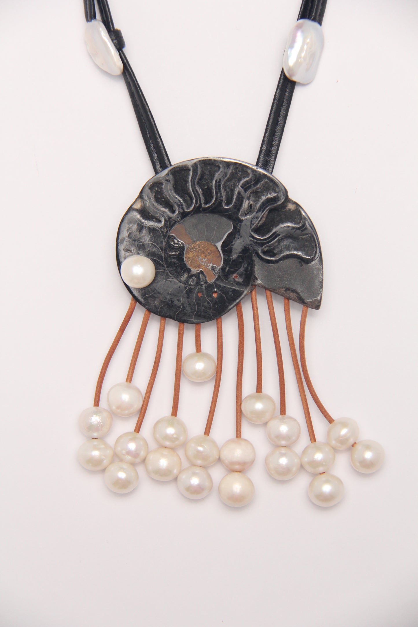 Pendant: ammonite fossil, leather, pearls