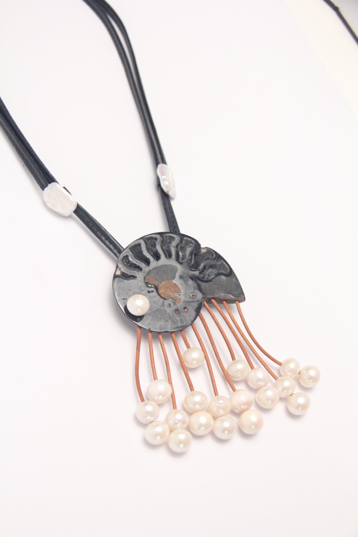Pendant: ammonite fossil, leather, pearls