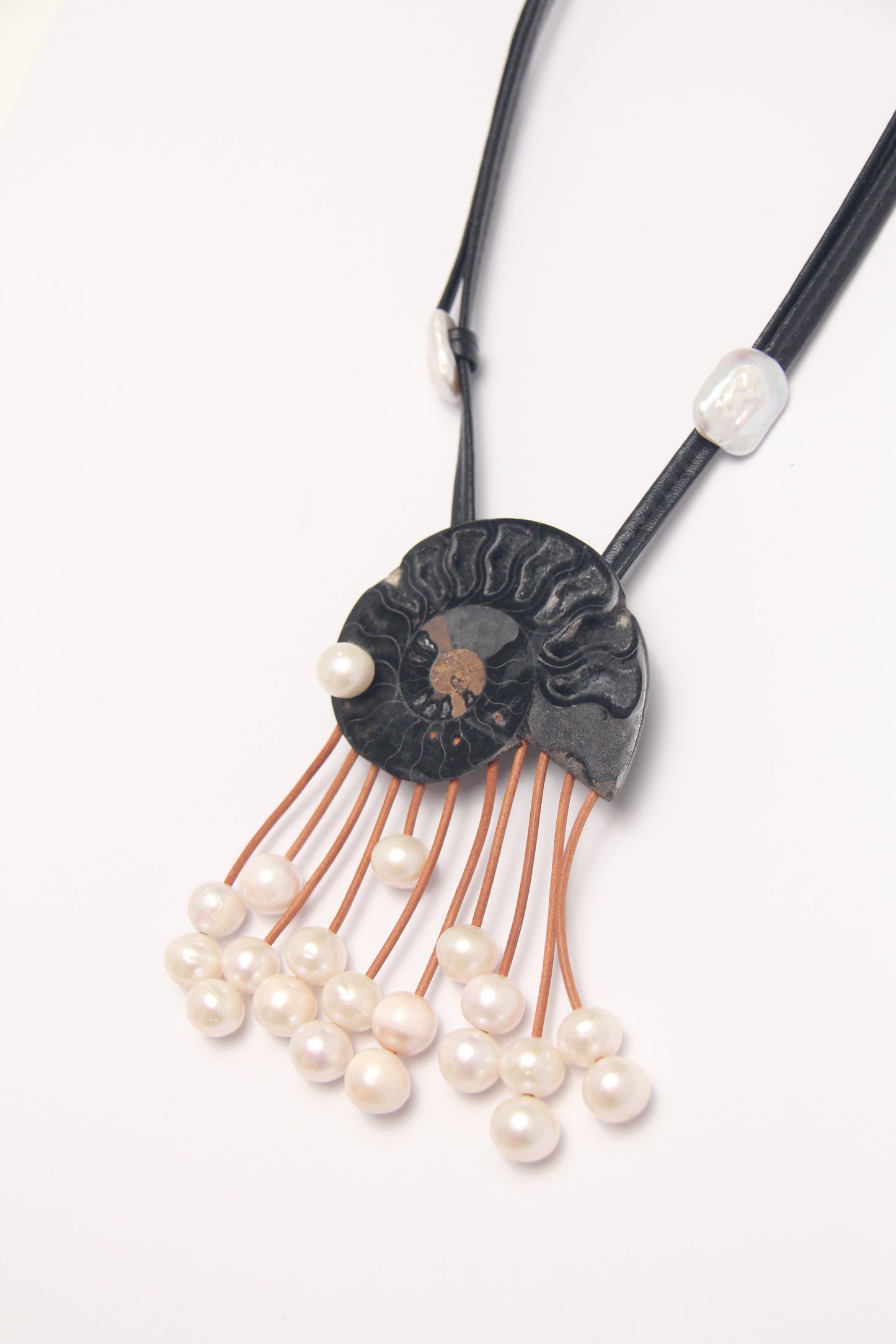 Pendant: ammonite fossil, leather, pearls
