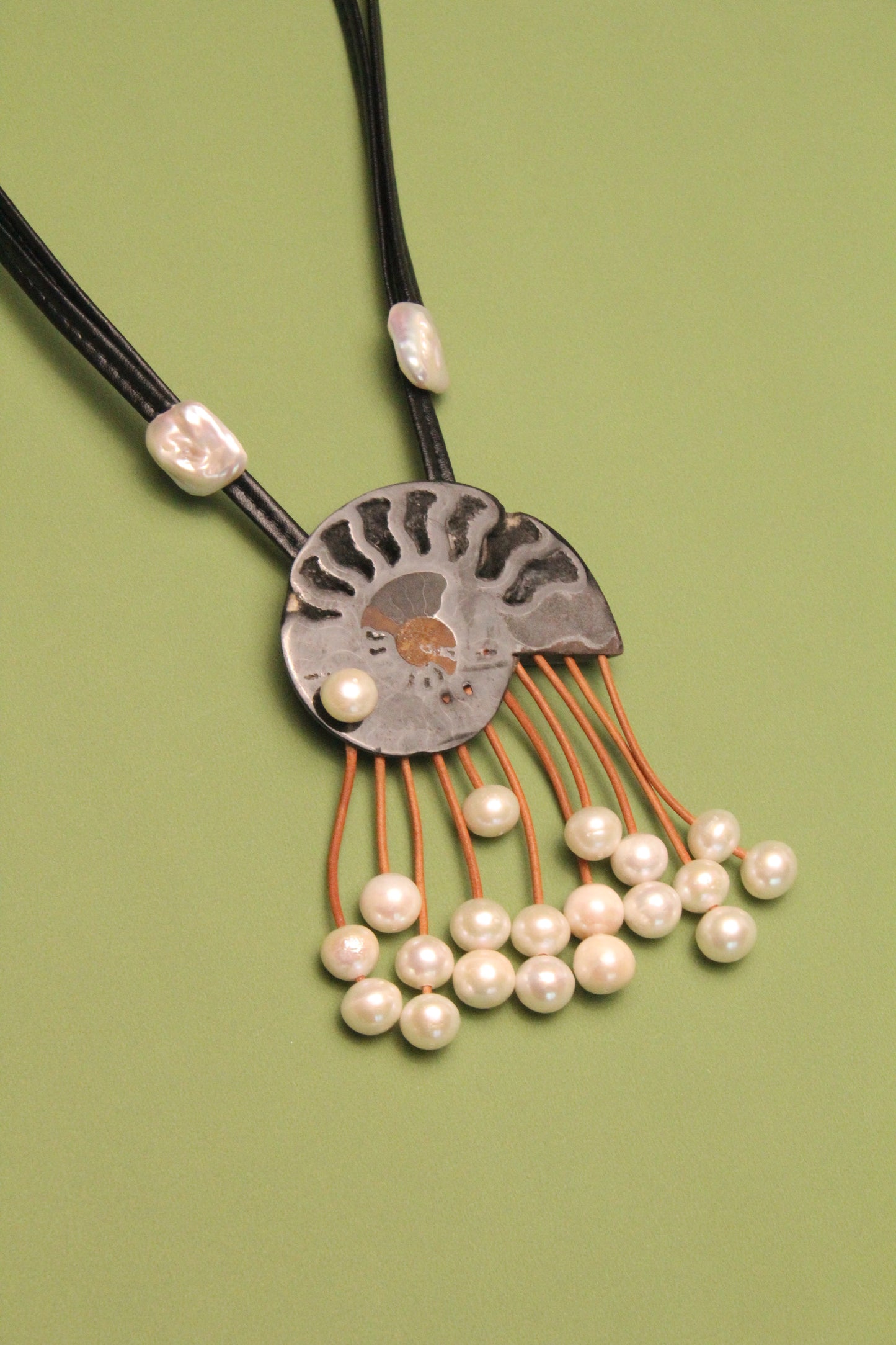Pendant: ammonite fossil, leather, pearls