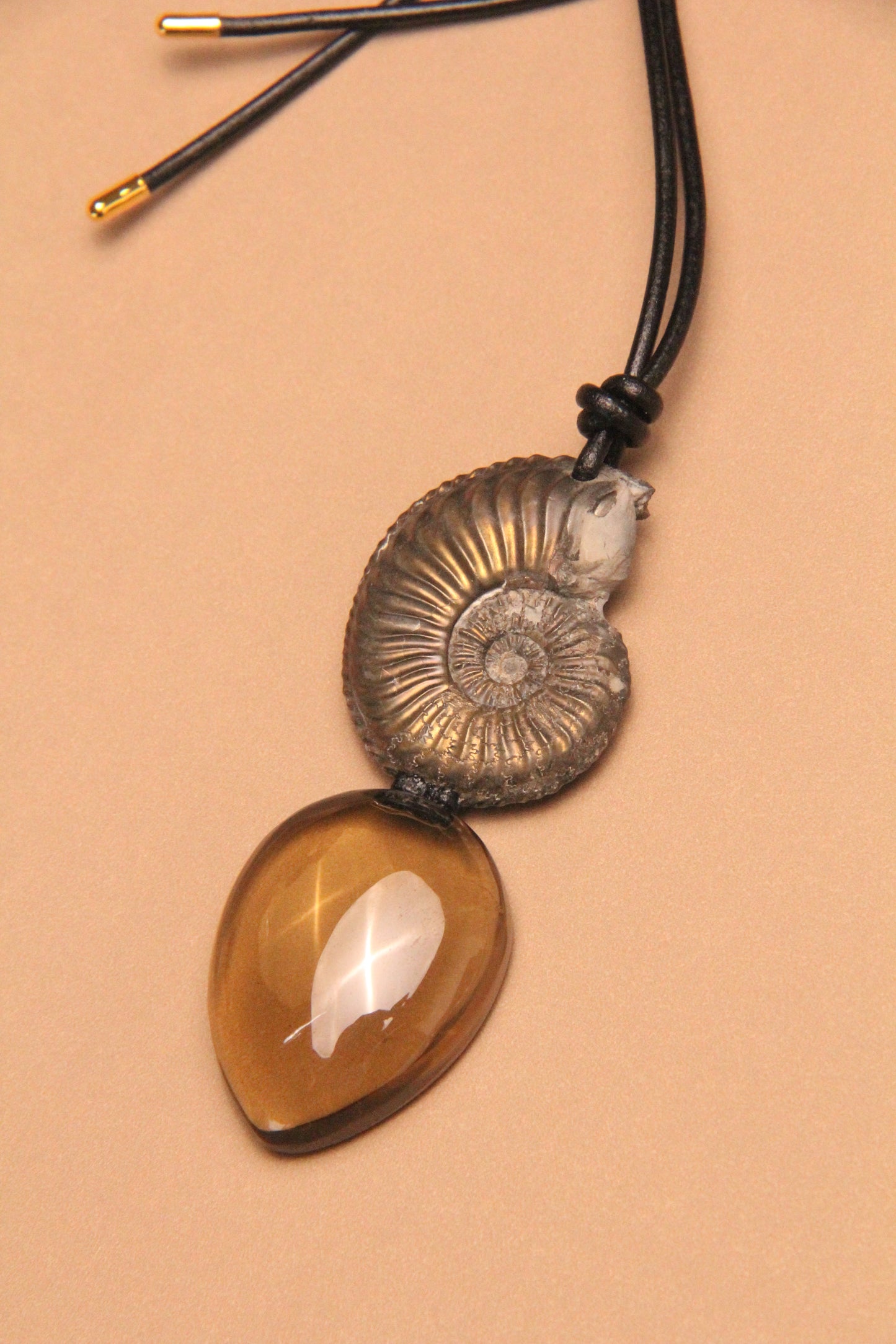 Pendant: ammonite fossil, citrine, leather