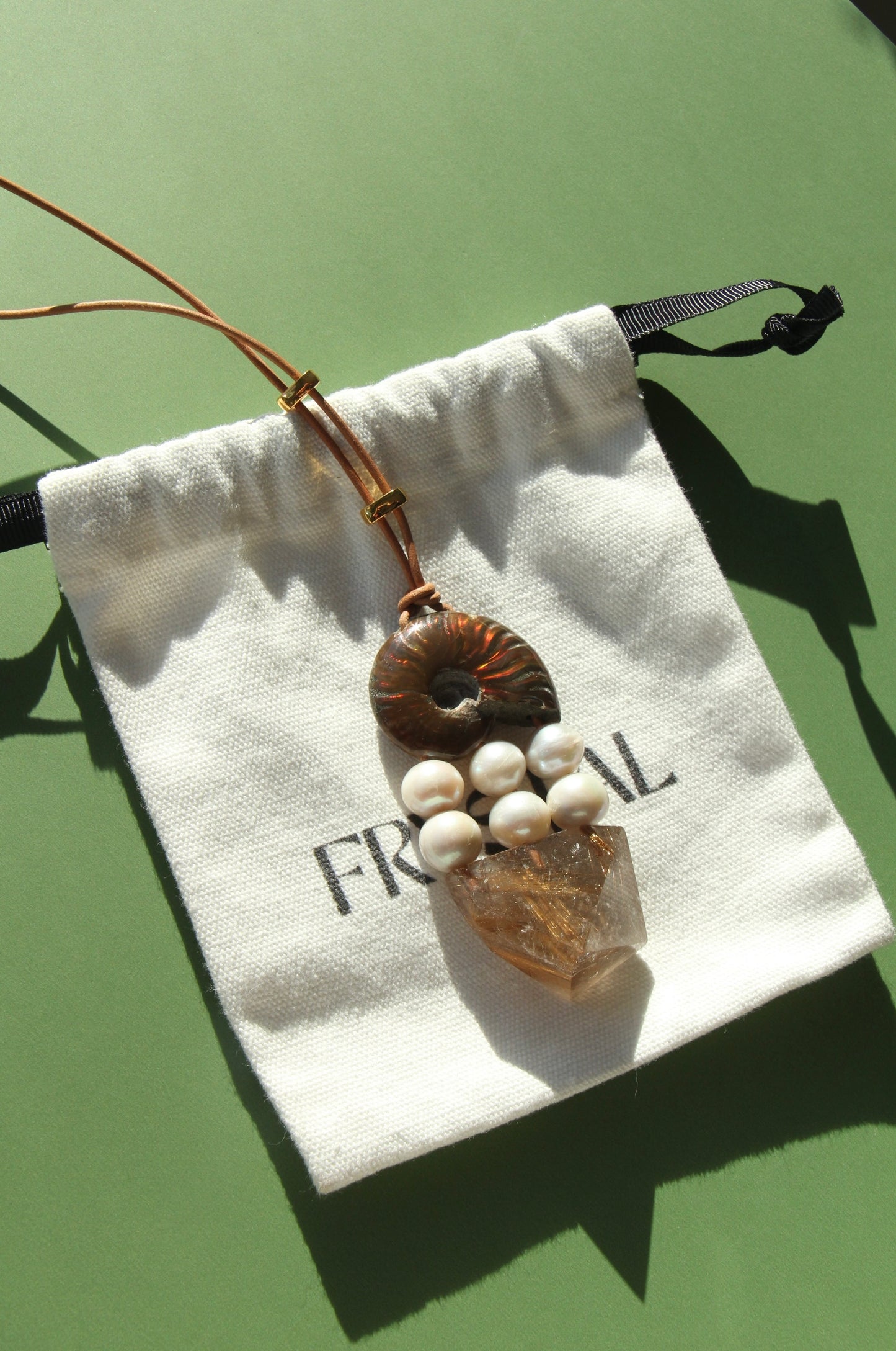 Pendant: ammonite, pearls, rutilated quartz