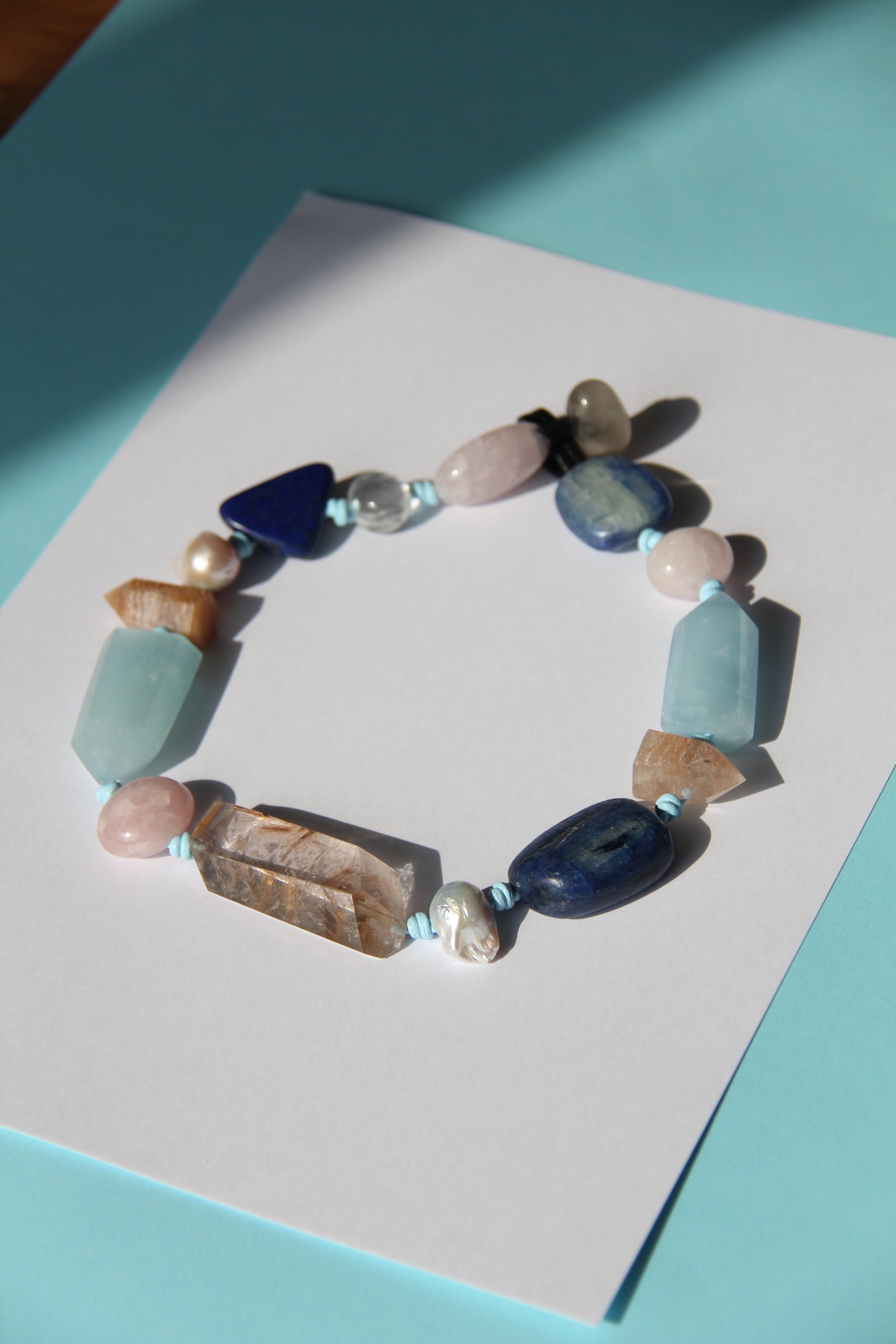 Necklace: golden hair rutilated quartz, aquamarine, kyanite, lapis lazuli, rose quartz, pearl, ghost quartz, white crystal, smoky quartz