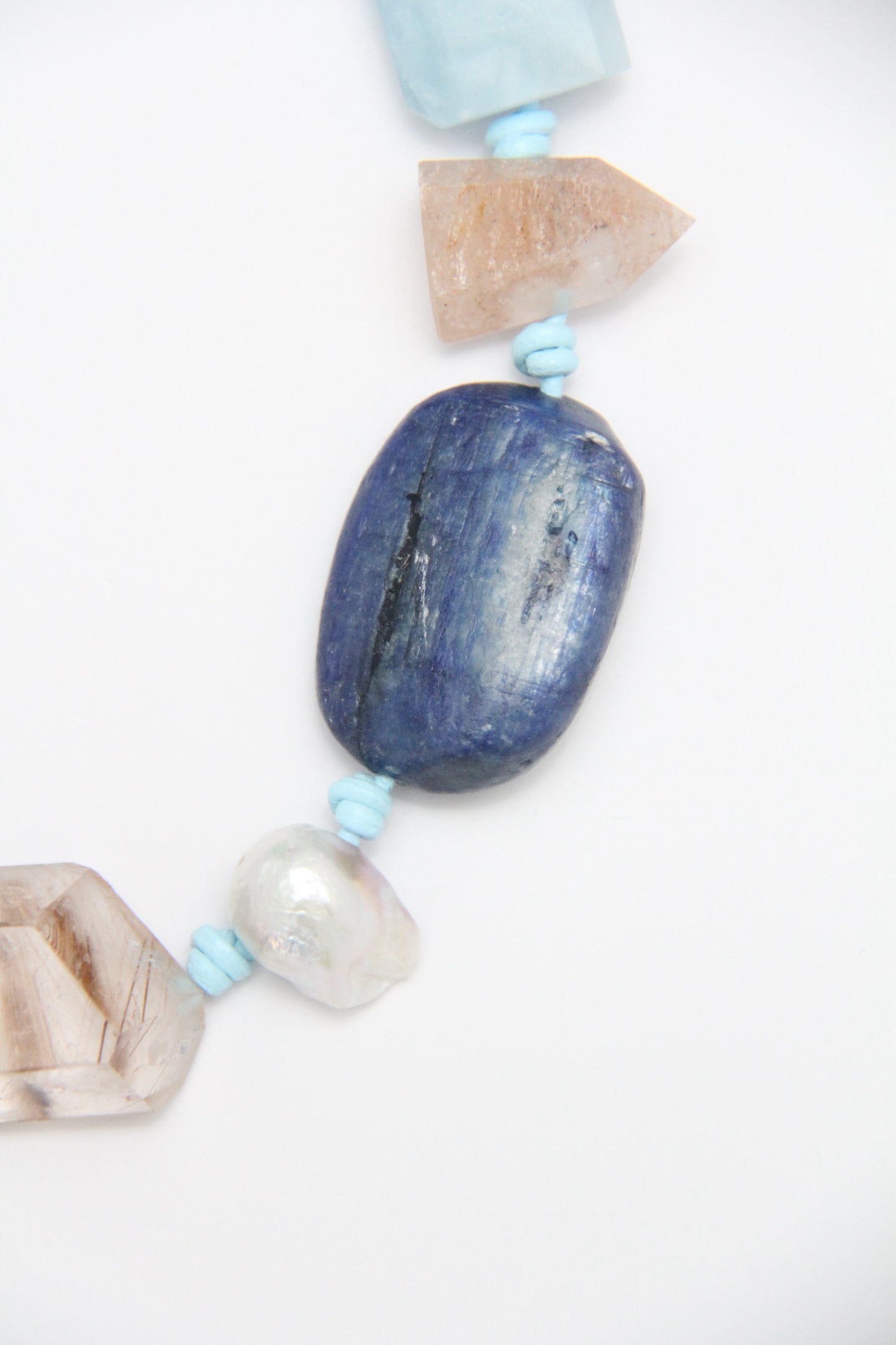 Necklace: golden hair rutilated quartz, aquamarine, kyanite, lapis lazuli, rose quartz, pearl, ghost quartz, white crystal, smoky quartz